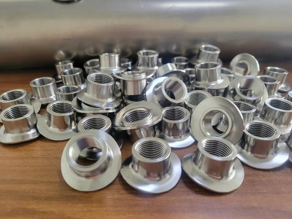 Titanium saddle bungs